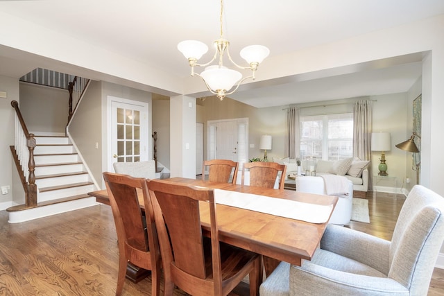 dining room featuring wood-type flooring and a chandelier