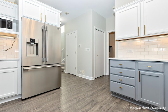 kitchen featuring gray cabinetry, high end refrigerator, hardwood / wood-style flooring, decorative backsplash, and white cabinetry