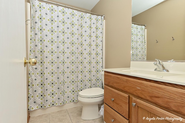 bathroom with tile patterned flooring, vanity, and toilet