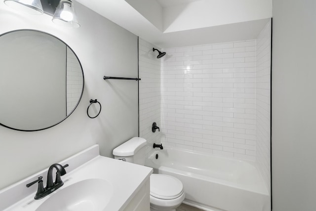 full bathroom with vanity, tiled shower / bath combo, and toilet