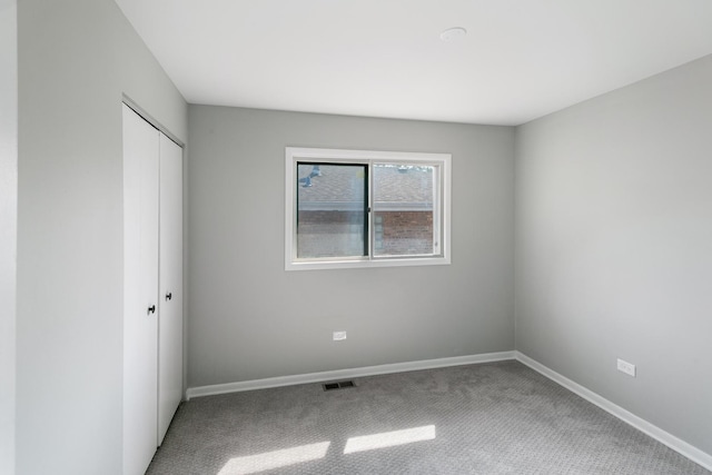 unfurnished bedroom with carpet flooring and a closet