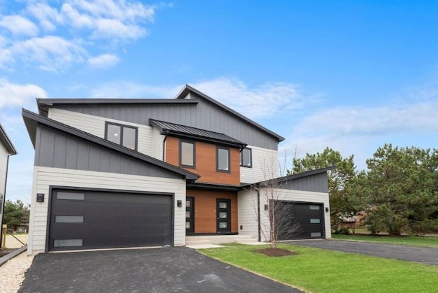 view of front facade with a garage and a front lawn