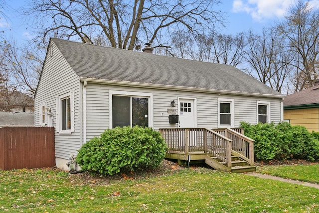 cape cod-style house with a deck and a front yard