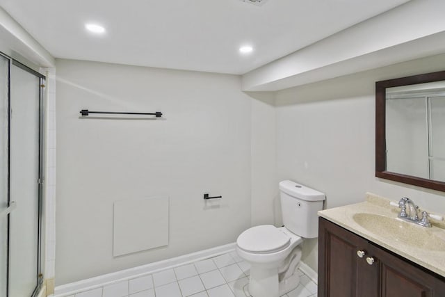 bathroom featuring a shower with door, vanity, and toilet