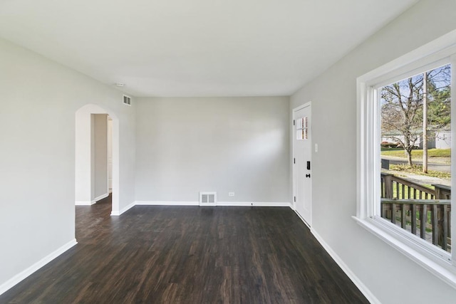 unfurnished room with dark hardwood / wood-style flooring