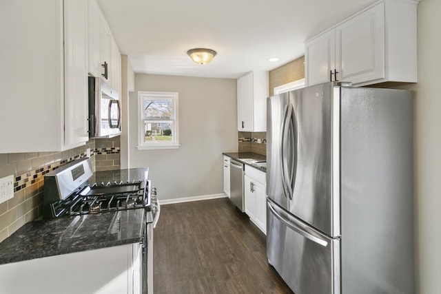 kitchen featuring stainless steel appliances, dark hardwood / wood-style flooring, backsplash, dark stone counters, and white cabinets