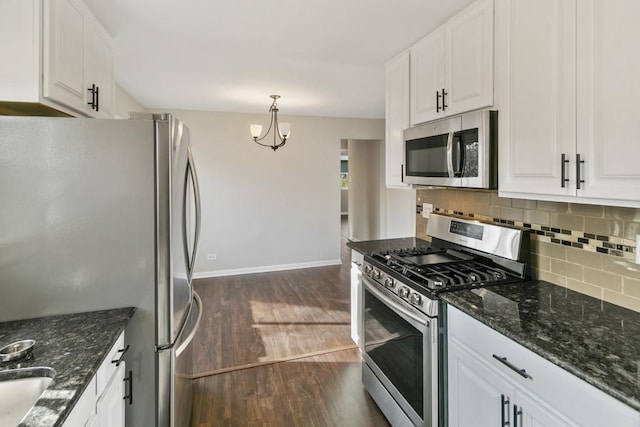 kitchen with a notable chandelier, white cabinets, dark hardwood / wood-style floors, decorative light fixtures, and stainless steel appliances