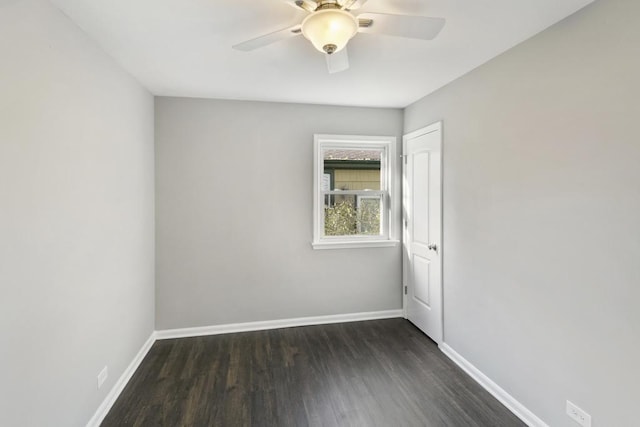 empty room with ceiling fan and dark hardwood / wood-style floors