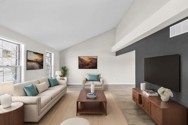 living room featuring vaulted ceiling and light wood-type flooring