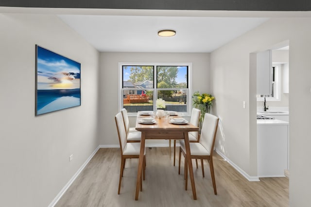 dining area featuring light hardwood / wood-style flooring and sink