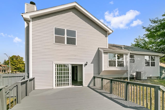 back of house with central AC unit and a deck