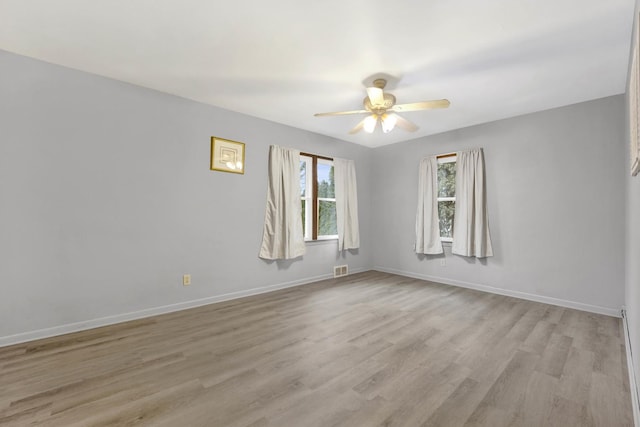 spare room with ceiling fan and light hardwood / wood-style flooring