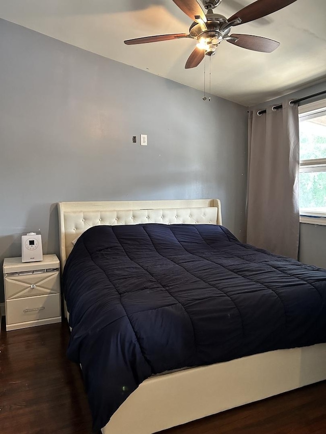 bedroom featuring dark hardwood / wood-style flooring and ceiling fan