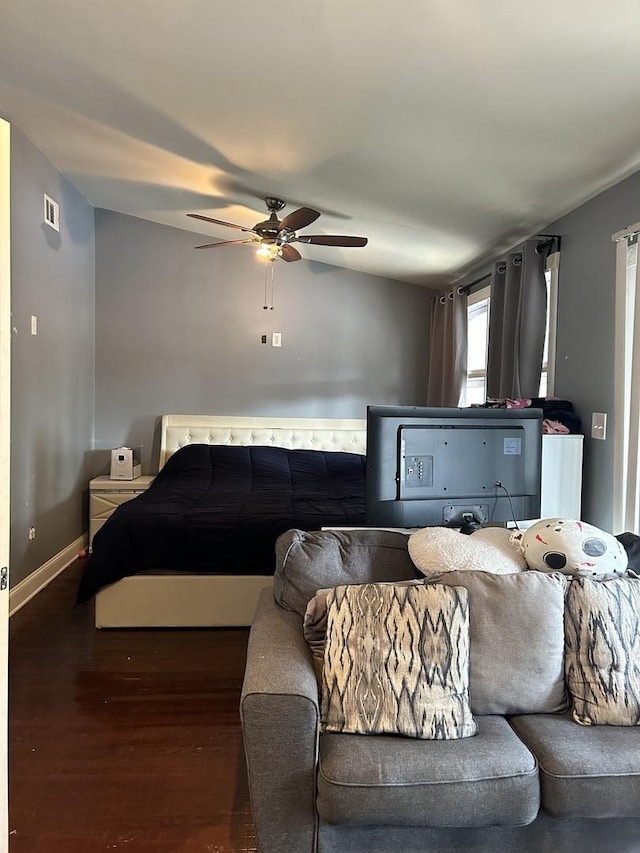 bedroom with ceiling fan and dark hardwood / wood-style floors