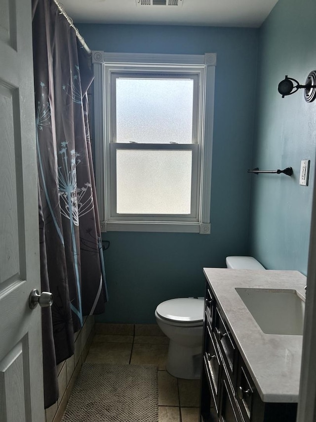 full bathroom with tile patterned floors, vanity, toilet, and shower / bath combo