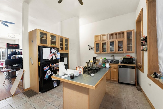 kitchen featuring ceiling fan, sink, kitchen peninsula, light tile patterned floors, and black appliances