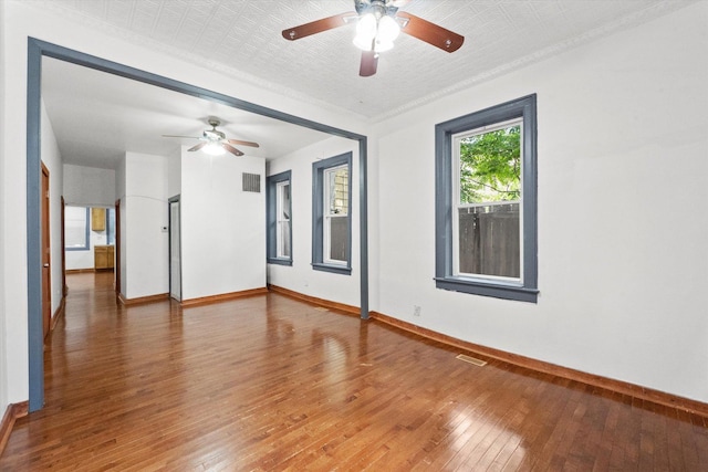 unfurnished room with hardwood / wood-style flooring and ceiling fan