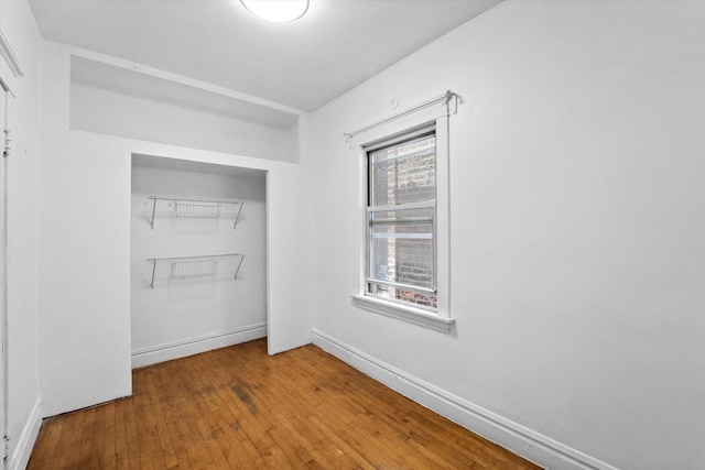 interior space with plenty of natural light and hardwood / wood-style floors