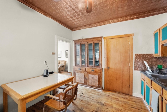 office space with light wood-type flooring and crown molding