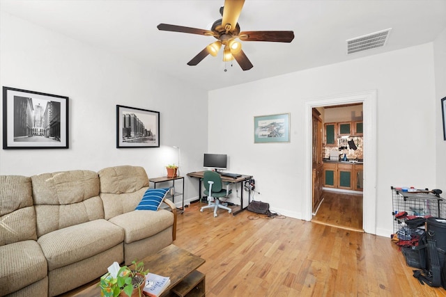 living room featuring hardwood / wood-style flooring and ceiling fan