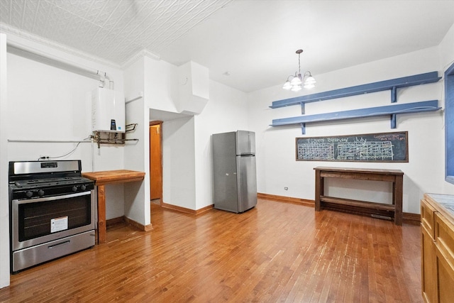 kitchen featuring tankless water heater, hanging light fixtures, appliances with stainless steel finishes, a notable chandelier, and wood-type flooring