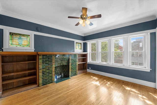 unfurnished living room with hardwood / wood-style flooring, ceiling fan, and ornamental molding