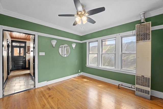 unfurnished room featuring crown molding, hardwood / wood-style floors, and ceiling fan