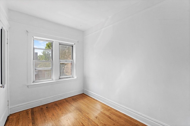 unfurnished room with hardwood / wood-style flooring