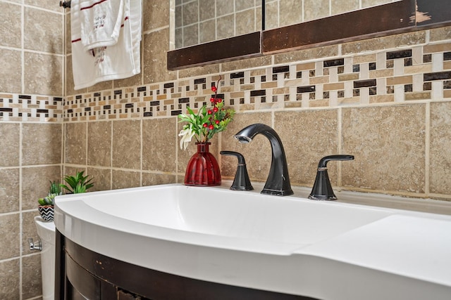 bathroom with backsplash, vanity, and tile walls