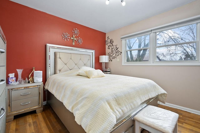 bedroom with dark hardwood / wood-style flooring