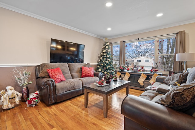 living room with light wood-type flooring and ornamental molding