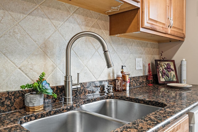 kitchen featuring tasteful backsplash and sink