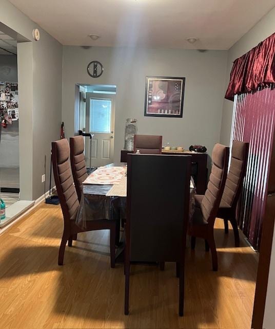 dining space featuring wood-type flooring