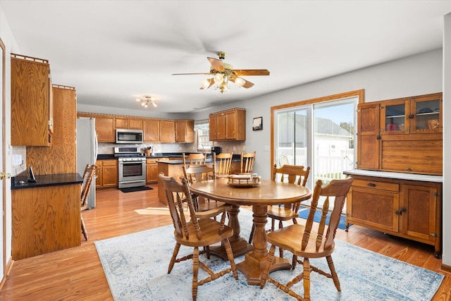 dining area featuring light hardwood / wood-style flooring and ceiling fan