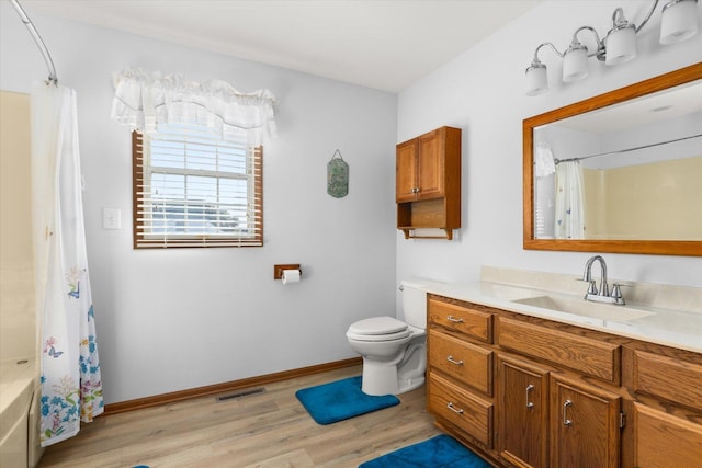 full bathroom featuring shower / bath combination with curtain, toilet, wood-type flooring, and vanity