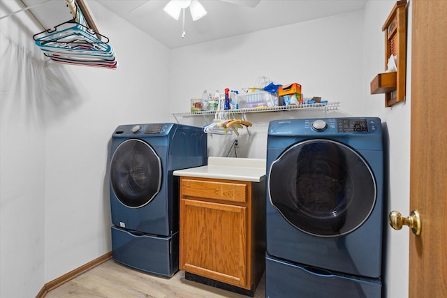 washroom with cabinets, light wood-type flooring, separate washer and dryer, and ceiling fan