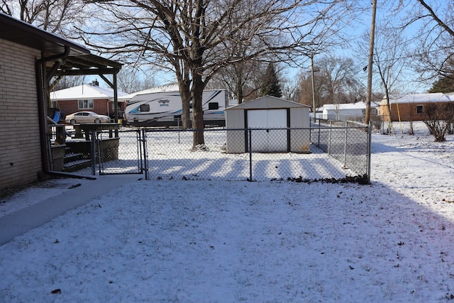 yard covered in snow with an outdoor structure and a garage