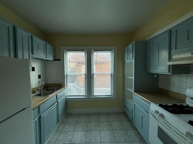 kitchen with light tile patterned floors, white appliances, tasteful backsplash, and sink