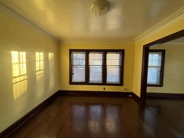 empty room with dark hardwood / wood-style floors and ornamental molding