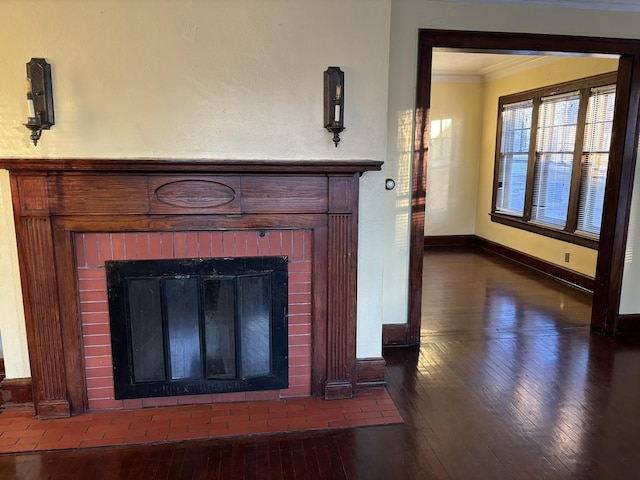 details featuring hardwood / wood-style flooring, a fireplace, and ornamental molding