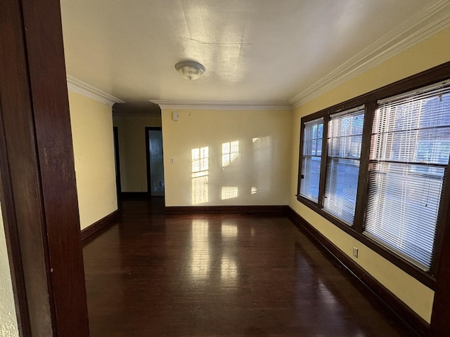 spare room with dark hardwood / wood-style flooring and ornamental molding