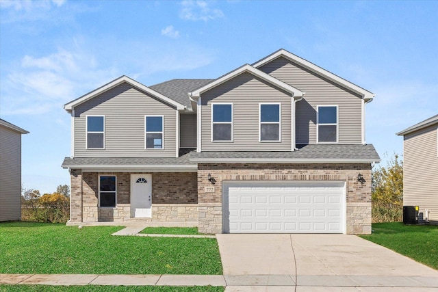 view of front of property with a garage, a front lawn, and central air condition unit