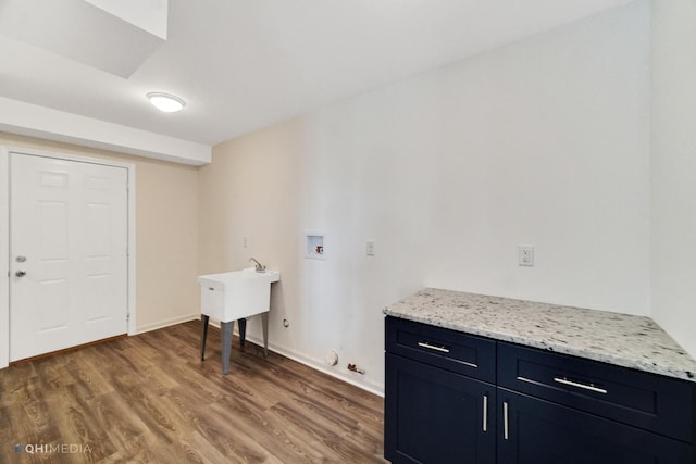 laundry area with cabinets, hookup for a washing machine, hardwood / wood-style flooring, and hookup for a gas dryer