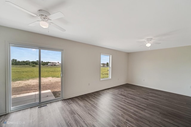 empty room with ceiling fan and dark hardwood / wood-style flooring