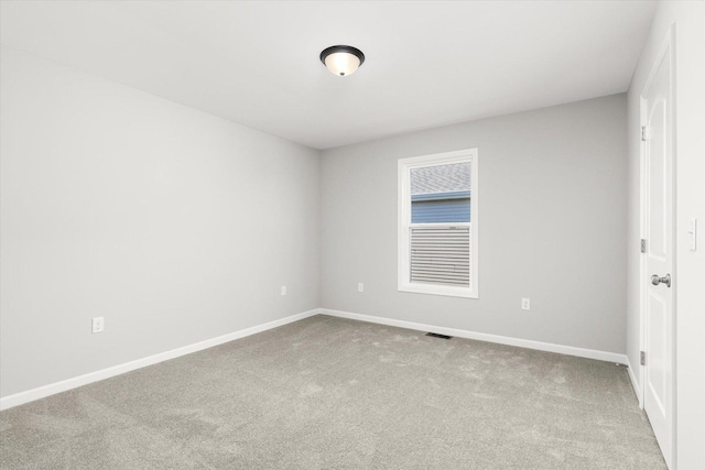 empty room featuring light carpet