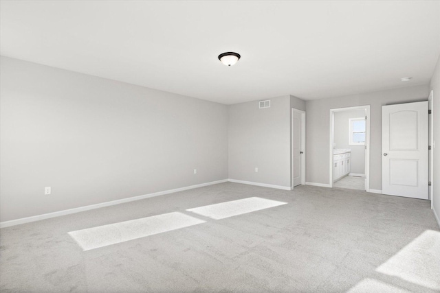 spare room featuring light colored carpet