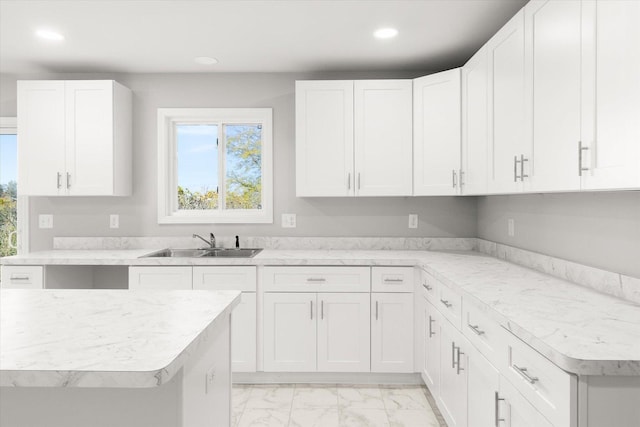 kitchen featuring white cabinetry and sink