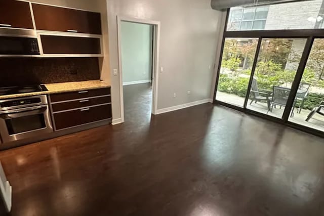 kitchen with dark brown cabinetry and black appliances