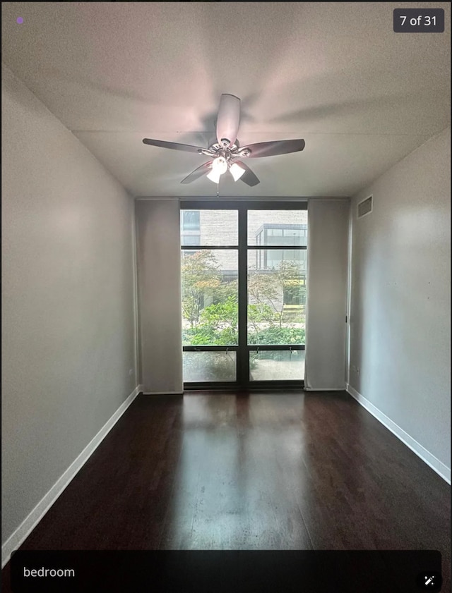 empty room featuring ceiling fan, dark hardwood / wood-style flooring, and a textured ceiling