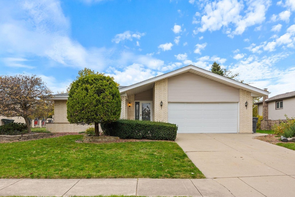 ranch-style house with a front lawn and a garage